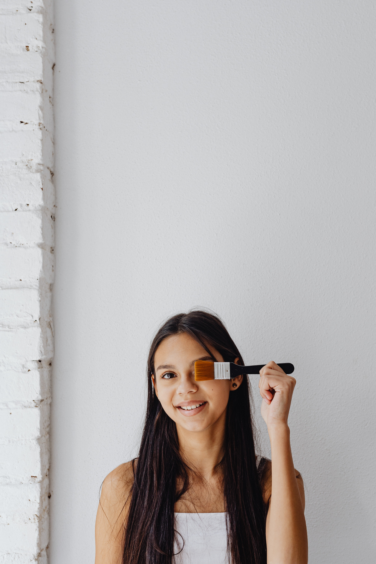 Woman Smiling while Holding a Paintbrush